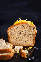 Lemon and poopy seeds pound cake on dark background