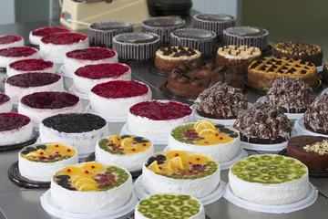 Cake and baking line.Industrial line of cakes. Many beautiful cakes on the table.Multicolored culinary products