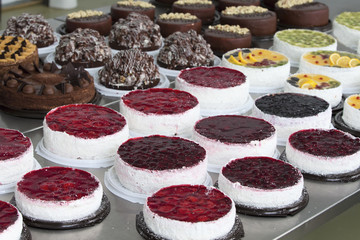Cake and baking line.Industrial line of cakes. Many beautiful cakes on the table.Multicolored culinary products