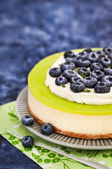 Delicious key lime cheesecake decorated with fresh blueberries