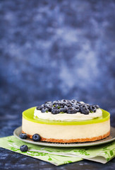 Delicious key lime cheesecake decorated with fresh blueberries