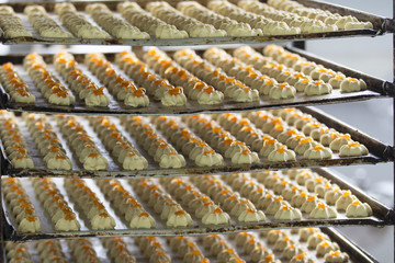 A lot of cookies in the professional kitchen. Culinary products on industrial potholes.Products from sand dough.short pastry cookies