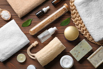 Obraz na płótnie Canvas Flat lay composition with spa cosmetics and towels on wooden background
