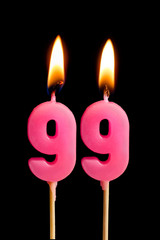 Burning candles in the form of 99 ninety nine (numbers, dates) for cake isolated on black...