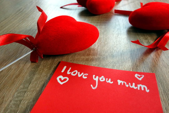 I love you mum message and hearts on wooden desk, Mother`s Day concept