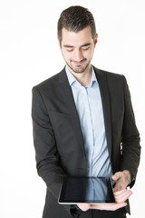 Portrait of a handsome young businessman holding a digital tablet smiling