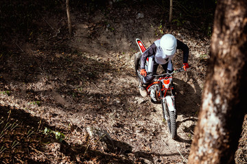 Trials motorcycle while competition in nature park