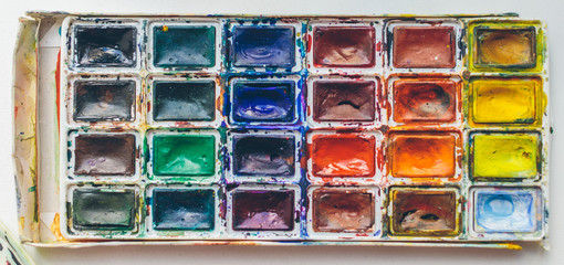 Brushes and paints on the table from the artist