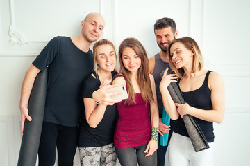 happy group of people from men and women practicing yoga in fun in the studio. groups of meditation and support in the yoga class. yoga, mate, man, woman, many people
