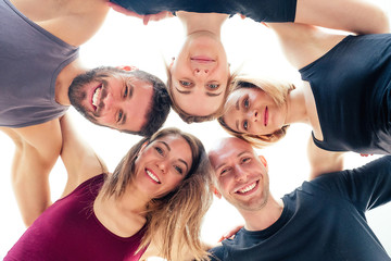 a happy group of people from men and women practicing yoga in the studio. groups of meditation , communication yoga class. the concept of group meditation and teamwork. coach and students in a circle