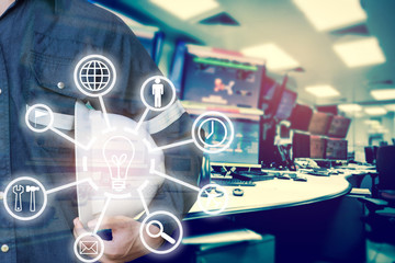 Obraz premium Double exposure of Engineer or Technician man with business industrial tool icons holding safety hat with monitor of computers room for oil and gas industrial business concept