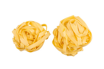 two balls of tagliatelle pasta isolated on white