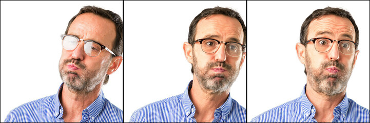 Obraz premium Middle age handsome man closeup puffing out cheeks, having fun making funny face