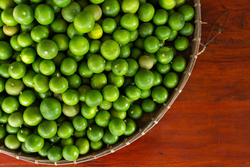 Fresh green limes on wooden in Thailand,copy space.