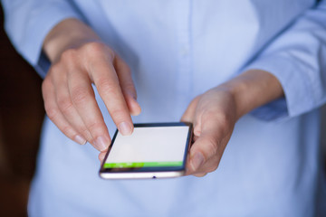 phone in female hands with blank screen close-up