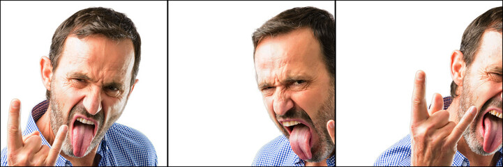 Middle age handsome man closeup making rock symbol with hands, shouting and celebrating with tongue out