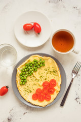 Omelette with green peas and cherry tomatoes. Protein breakfast