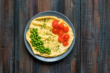 Omelette with green peas and cherry tomatoes. Protein breakfast