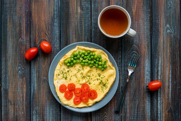 Omelette with green peas and cherry tomatoes. Protein breakfast