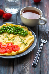 Omelette with green peas and cherry tomatoes. Protein breakfast