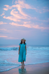 Woman at the seashore of Indian ocean after sunset