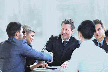 two business partners shaking hands on meeting