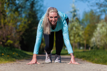 Young woman is stretching in a sport dress