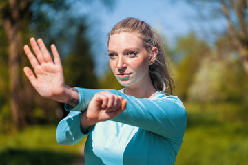 Young woman is stretching in a sport dress