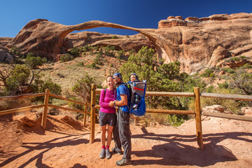 Fototapeta na wymiar A family with baby son visits Arches National Park in Utah, USA