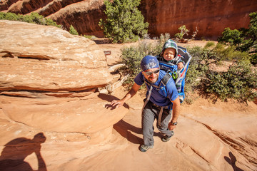 A family with baby son visits Arches National Park in Utah, USA