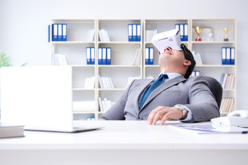 Businessman with virtual reality glasses in modern technology co