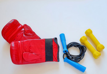 Red gloves, black yellow jump rope and dumbbells for the boxer athlete. Isolated on white background. Segarty for training boxer striking technique for Boxing grosee