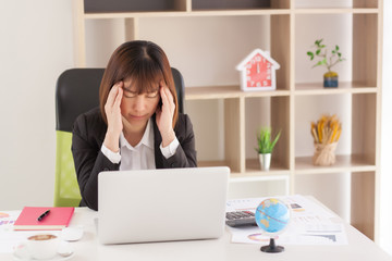 the women are stressed at work in the office. Asian beautiful woman stressful and headache with laptop computer. Young business woman with headache at office, feeling sick at work.