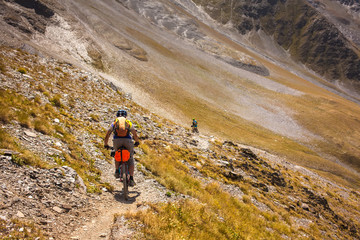 Fototapeta premium Mountain bikers are travelling in the highlands of Tusheti region, Georgia