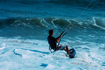 Kitesurfer on a beautiful background of spray during the sunset