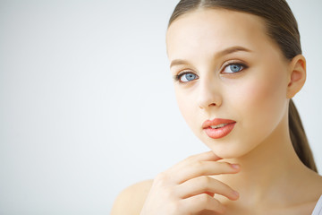 Obraz na płótnie Canvas Beauty face of woman with cosmetic cream on face