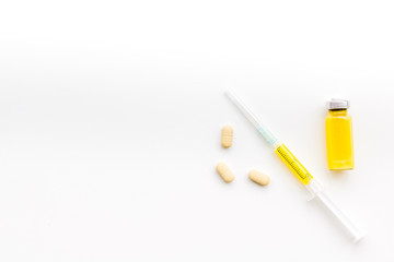 Medical therapy. Syringe, bottle with drug, pills on white background top view copy space