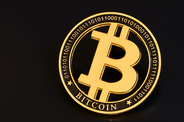Gold bitcoin coin stacked against a dark background close-up. Bitcoin cryptocurrency. Bitcoin crypto-currency. Anonymous. BTC                            