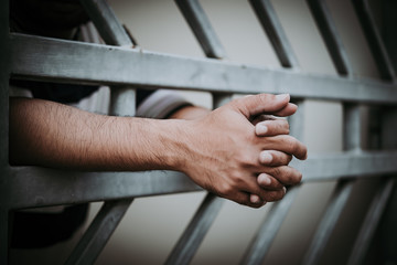 Hands of men desperate to catch the iron prison,prisoner concept,thailand people,Hope to be free,A person guilty are punished.