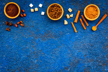 Flavouring products for making desserts. Cinnamon, cocoa, coffee on blue table top view space for text