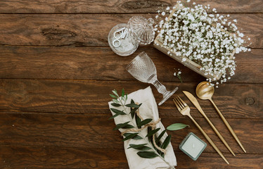 Wedding table decoration in rustic style on wooden background. Top view, flat lay, copy space