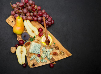 Slice of French Roquefort cheese and pear on wooden board