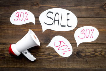 Sale concept with megaphone. Declare the sale. Electronic megaphone near word sale in cloud on dark...