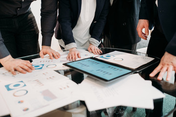 business team communication. results review. data analysis. men and women looking at documents discussing work moments