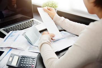 Woman calculating her Debt.