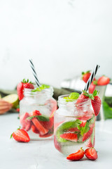 Alcohol cocktail mojito lemonade with rum, soda, strawberry and basil