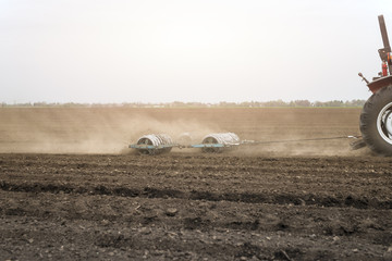Agriculture machinery cultivating field for the season.