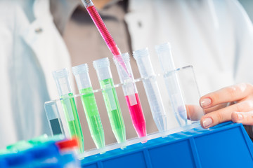 Chemical laboratory scientist woman working with pipette