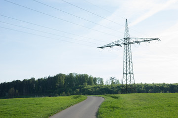 power pole with blue sky and a street in nature