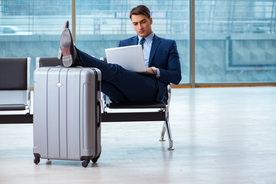 Businessman waiting at the airport for his plane in business cla